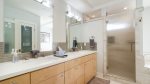Master bathroom has large vanity, step-in shower and jetted tub.